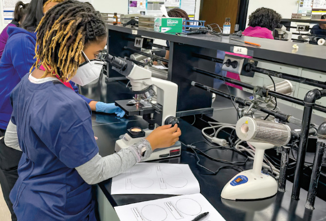 Enlargeable photo of a student working in a lab