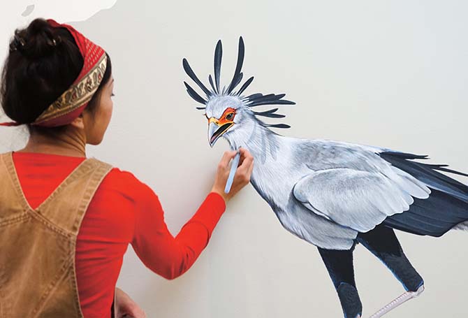 An artist painting a bird
