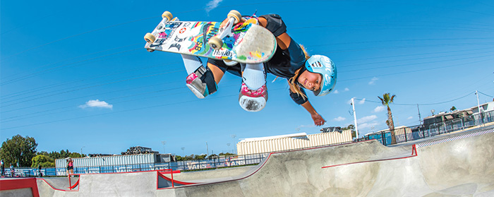 Photo of a female skateboarder performing a trick