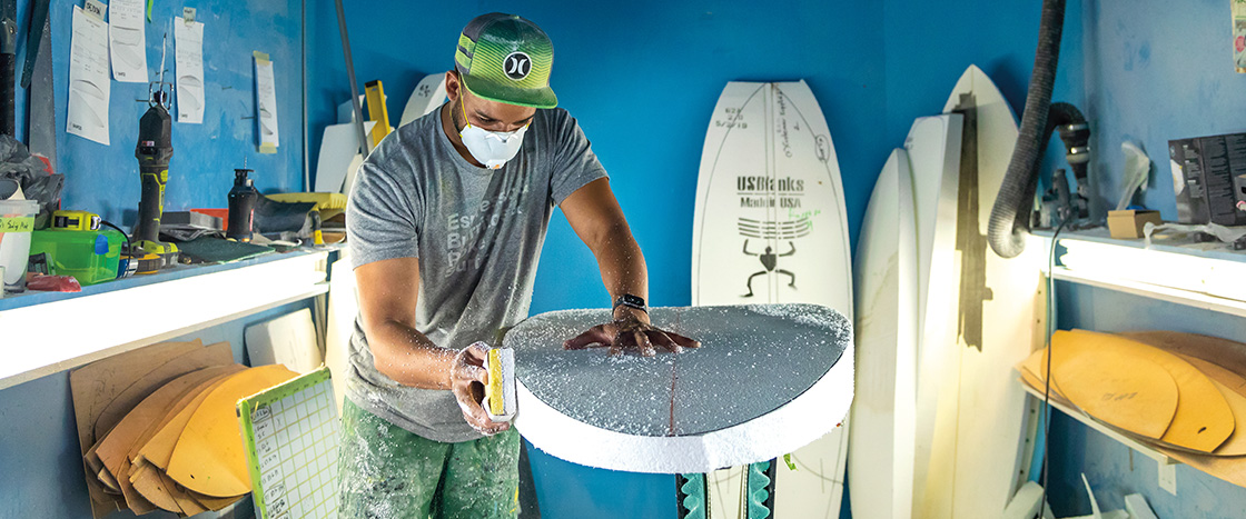 Image of a person making a surfboard