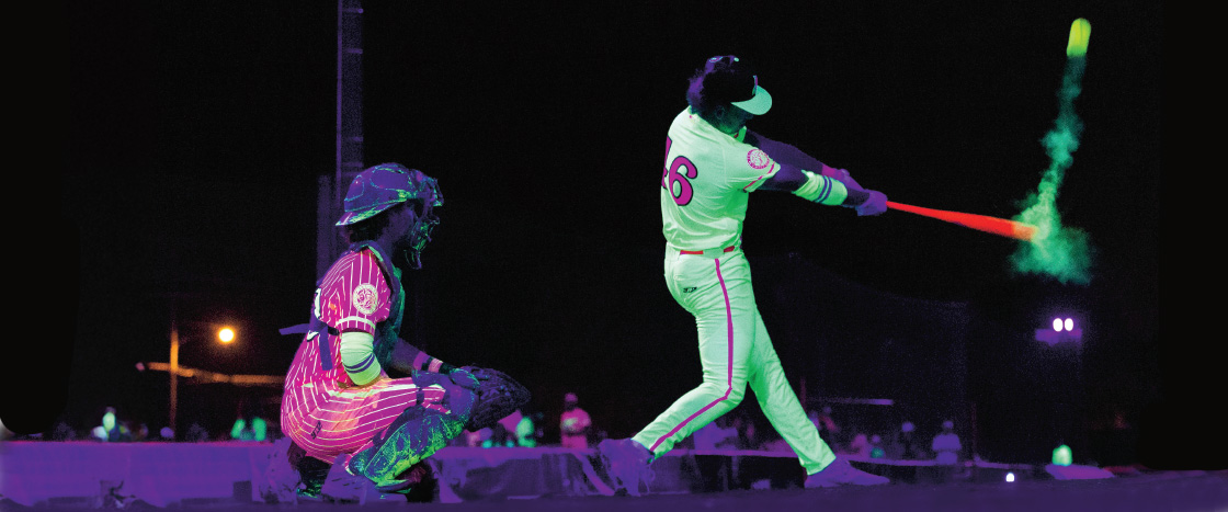 Image of people playing glow in the dark baseball