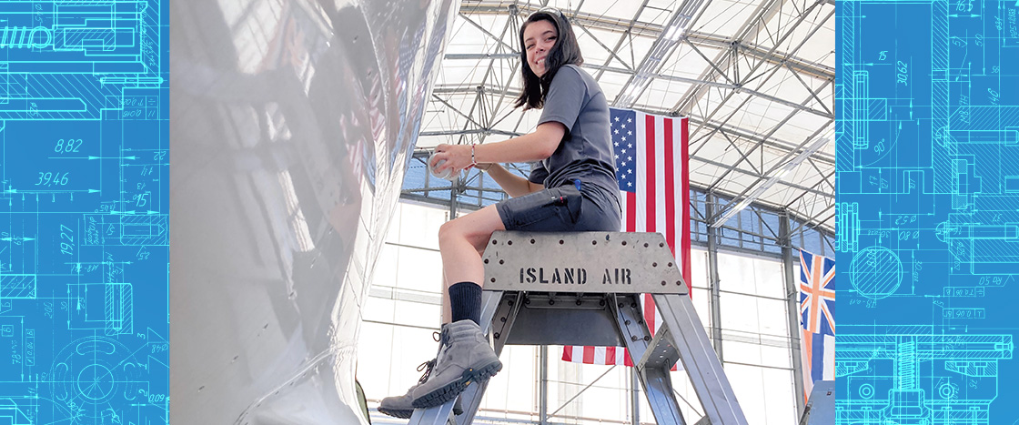 Image of airplane mechanic sitting on raised metal seat while working on plane